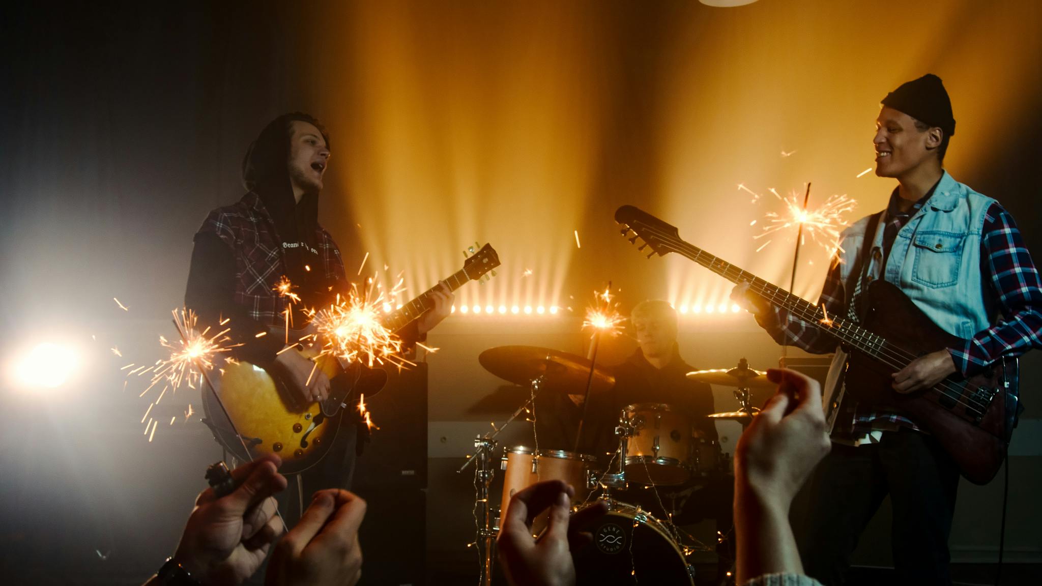 Dynamic live band show with guitars and sparklers creating a vibrant and exciting atmosphere.